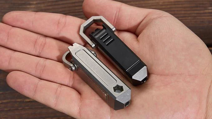 Grey and DLC black Ti-Capsule tools held in one hand